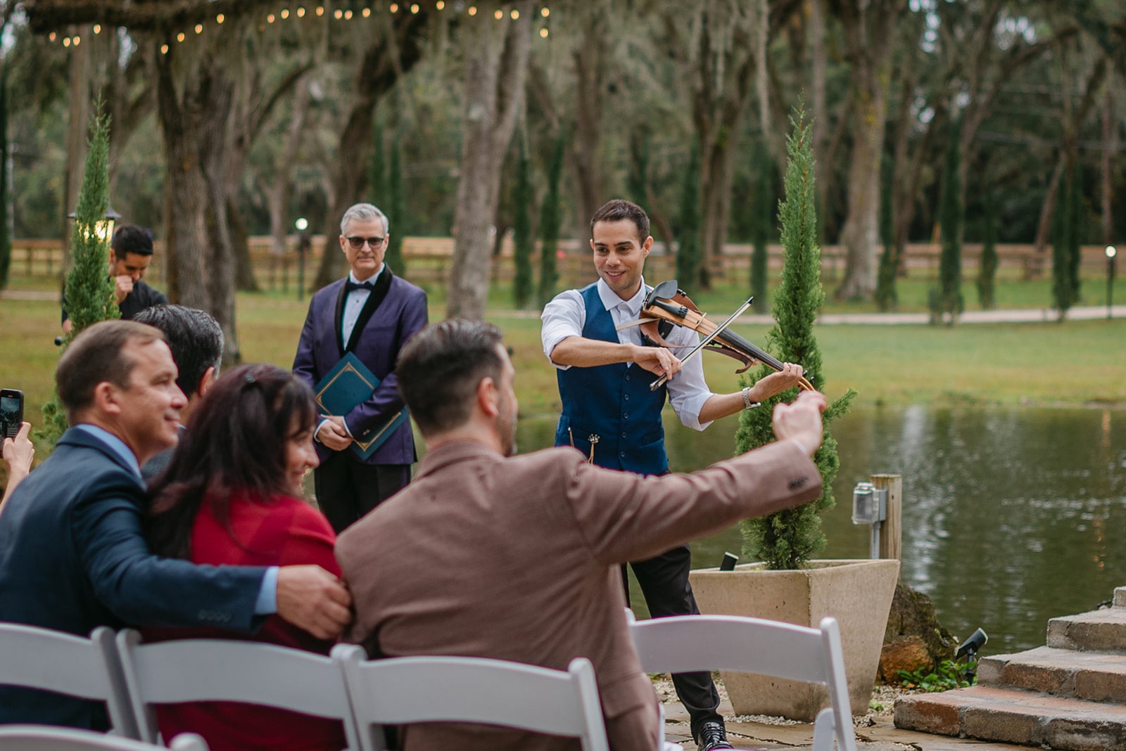 Guests reacting during a lakeside wedding ceremony in Central Florida