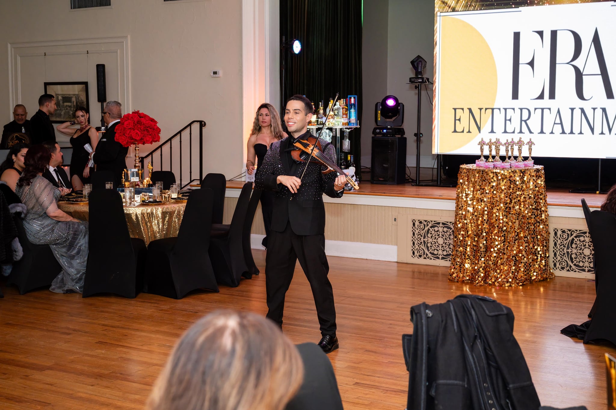 Guests at a formal gala watching David Chirinos perform
